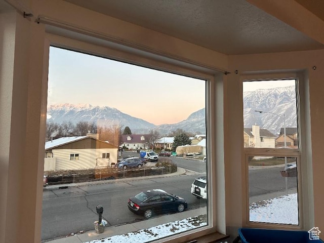 doorway to outside featuring a mountain view and a textured ceiling
