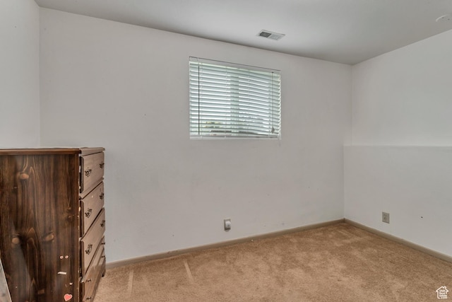 unfurnished room featuring light carpet