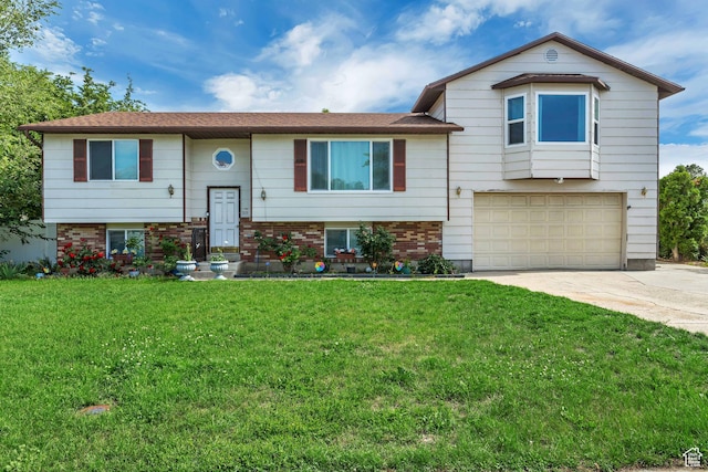 raised ranch with a garage and a front lawn