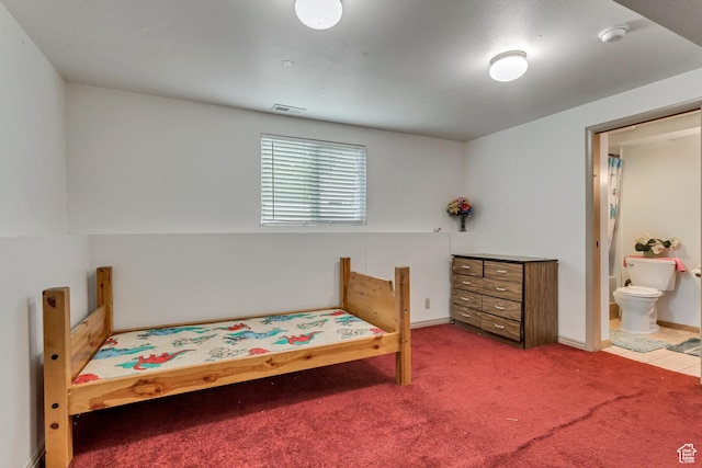 bedroom featuring carpet floors and ensuite bath