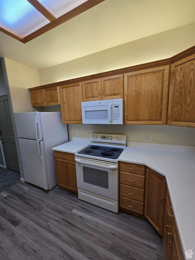 11075 S Grape Arbor Pl E Unit 103, Sandy, UT 84070 - kitchen featuring brown cabinets, white appliances, and dark wood finished floors