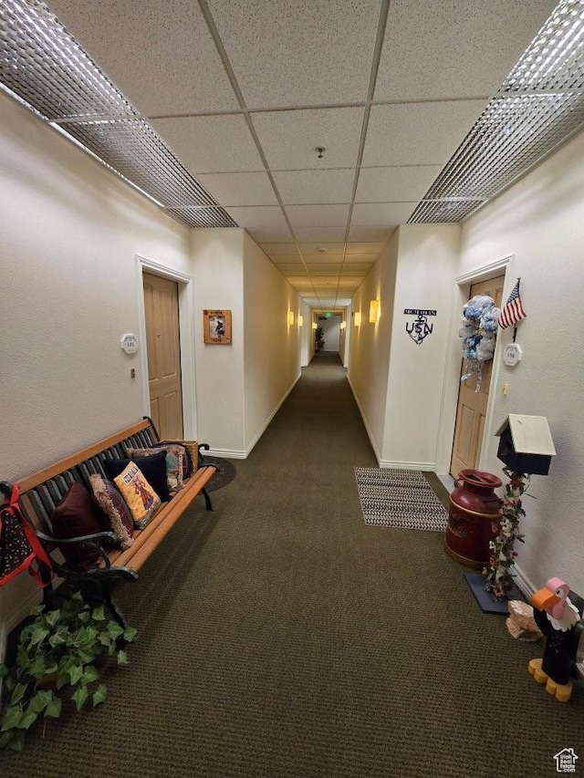 11075 S Grape Arbor Pl E Unit 103, Sandy, UT 84070 - hallway with dark colored carpet, a paneled ceiling, and baseboards