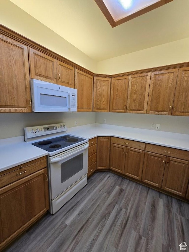 11075 S Grape Arbor Pl E Unit 103, Sandy, UT 84070 - kitchen with dark wood finished floors, brown cabinetry, white appliances, and light countertops