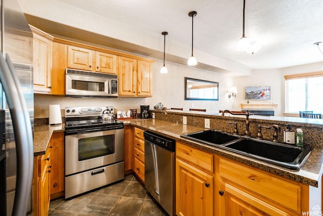 2653 Canyon Resort Dr Unit 227, Park City, UT 84098 - kitchen featuring pendant lighting, sink, a healthy amount of sunlight, kitchen peninsula, and stainless steel appliances