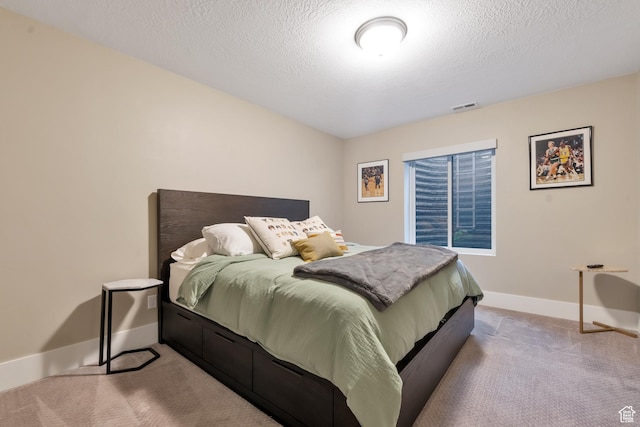 bedroom with visible vents, baseboards, carpet, and a textured ceiling