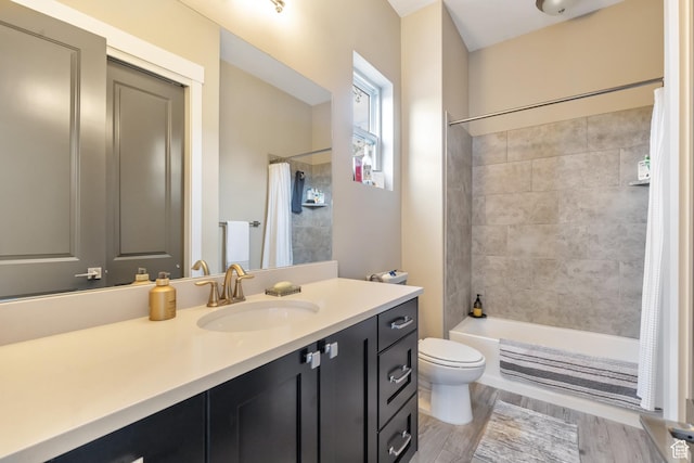 full bath featuring shower / bathtub combination with curtain, vanity, toilet, and wood finished floors