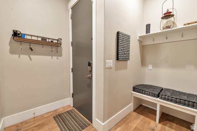 mudroom featuring wood finished floors and baseboards