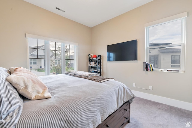 bedroom with visible vents, baseboards, and carpet