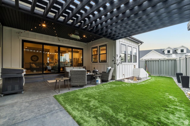 rear view of house with a yard, board and batten siding, fence, a patio, and an outdoor hangout area