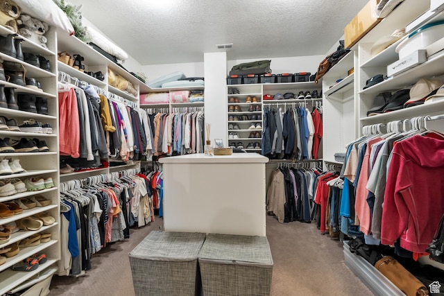 walk in closet with visible vents and carpet floors