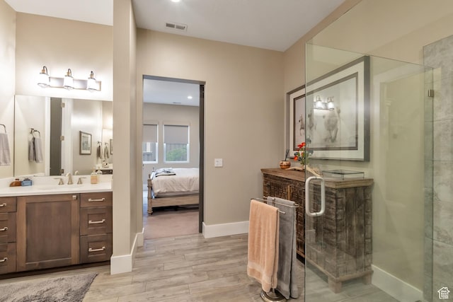 bathroom featuring vanity, ensuite bath, a shower stall, visible vents, and wood finished floors