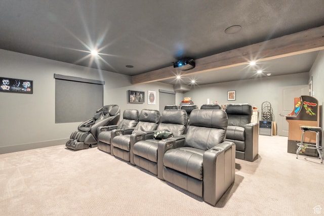 home theater featuring light carpet and baseboards
