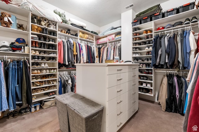 walk in closet featuring visible vents and carpet flooring