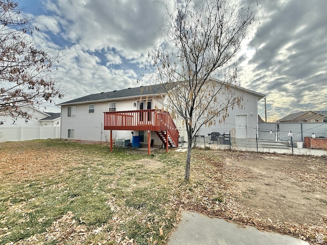 952 W 675 N, Tremonton, UT 84337 - rear view of house featuring a wooden deck, a yard, and central AC unit