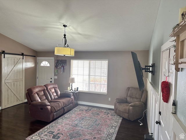952 W 675 N, Tremonton, UT 84337 - living room with dark wood-type flooring, a barn door, vaulted ceiling, and a textured ceiling
