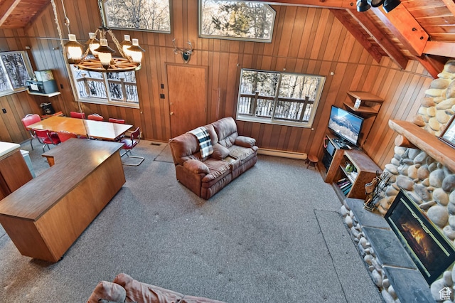 51 Aspen Loop 51&52, Oakley, UT 84055 - carpeted living area featuring a baseboard radiator, wooden walls, a chandelier, wooden ceiling, and a glass covered fireplace
