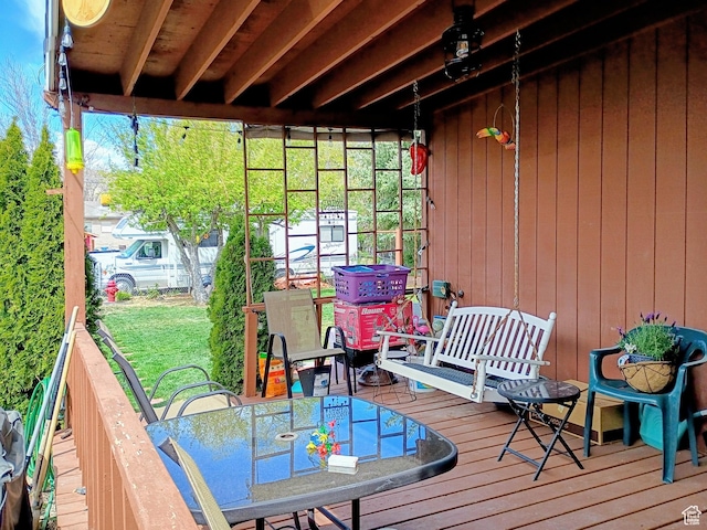 wooden terrace with outdoor dining space