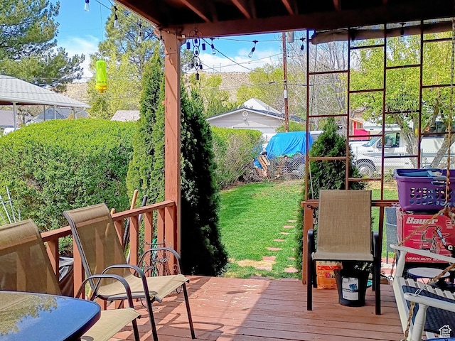wooden deck with fence and a lawn