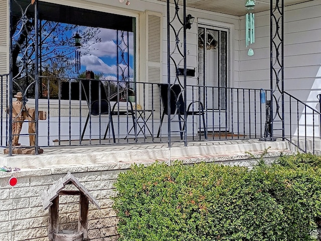 view of exterior entry with a porch