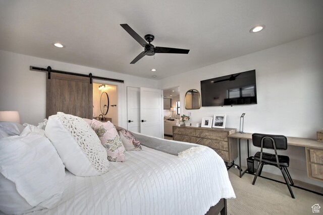 585 N Amber Ln, Garden City, UT 84028 - bedroom with light carpet, a barn door, and ceiling fan