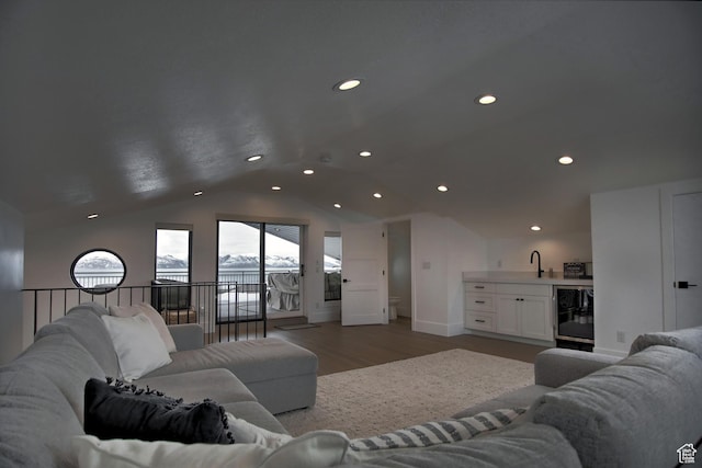 585 N Amber Ln, Garden City, UT 84028 - living room with hardwood / wood-style floors, wine cooler, vaulted ceiling, and sink