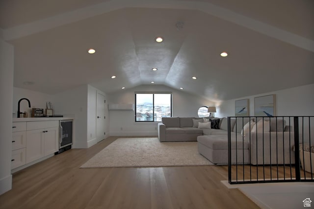 585 N Amber Ln, Garden City, UT 84028 - living room featuring light hardwood / wood-style flooring, indoor bar, beverage cooler, and vaulted ceiling