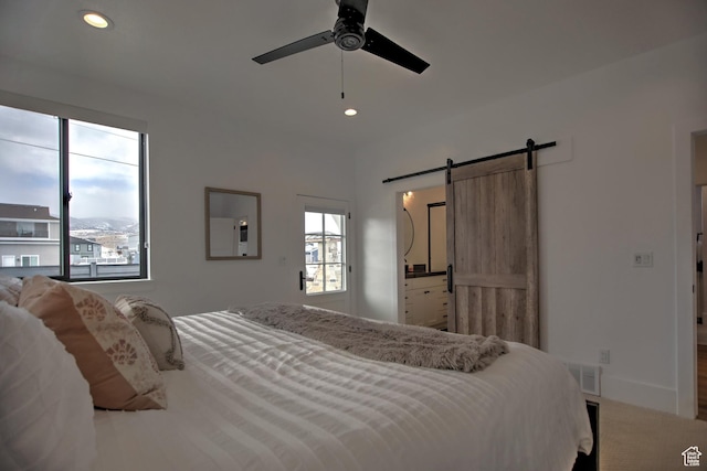 585 N Amber Ln, Garden City, UT 84028 - bedroom featuring ceiling fan, a barn door, and carpet floors