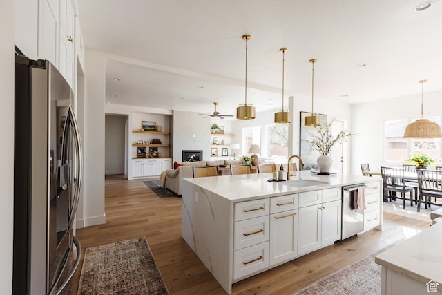 3305 W 2610 S, Hurricane, UT 84737 - kitchen with white cabinetry, appliances with stainless steel finishes, a sink, and decorative light fixtures
