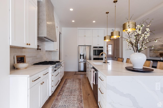 3305 W 2610 S, Hurricane, UT 84737 - kitchen featuring a sink, stainless steel appliances, a large island with sink, decorative backsplash, and custom range hood