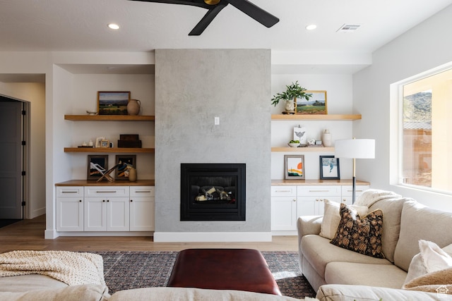 3305 W 2610 S, Hurricane, UT 84737 - living room with visible vents, recessed lighting, ceiling fan, a large fireplace, and light wood-style floors