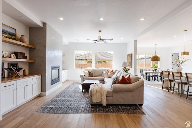 3305 W 2610 S, Hurricane, UT 84737 - living area with light wood finished floors, plenty of natural light, a fireplace, and a ceiling fan