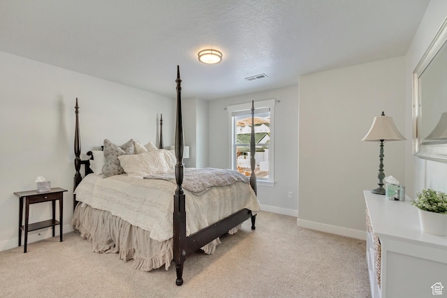 bedroom featuring baseboards, light colored carpet, and visible vents