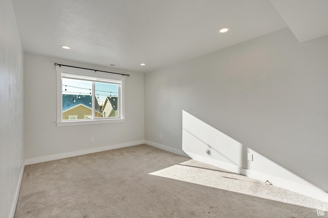 carpeted empty room with baseboards and recessed lighting