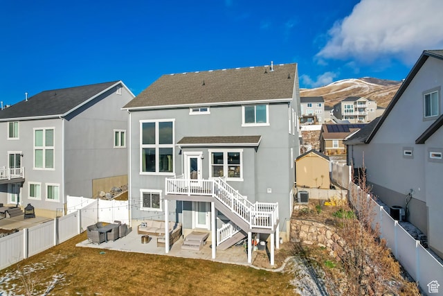 back of house with an outdoor living space, a residential view, a patio area, a fenced backyard, and a shingled roof