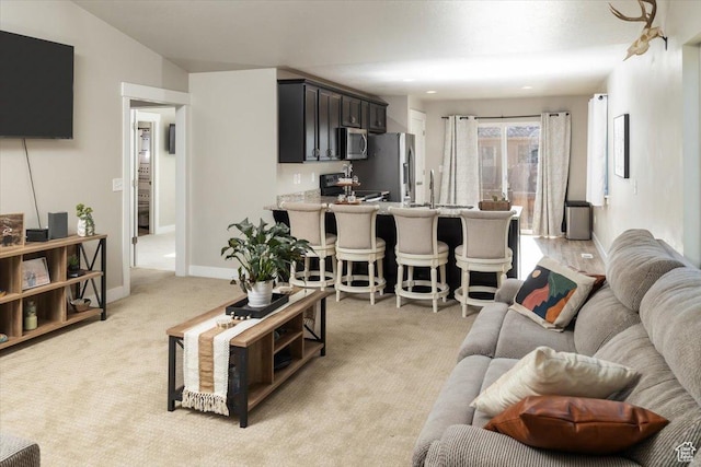 living room with sink and light colored carpet