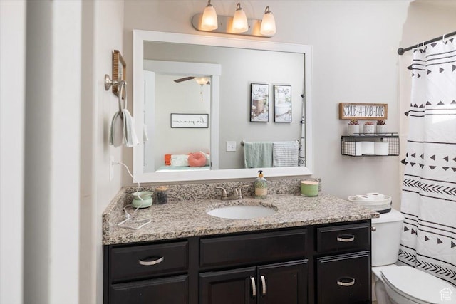 bathroom featuring vanity, toilet, and ceiling fan