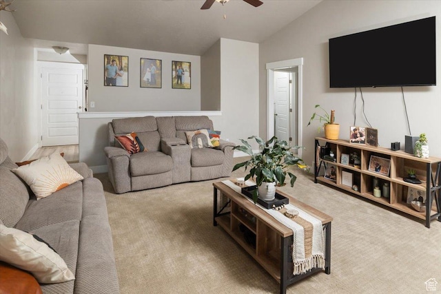 living room featuring ceiling fan, lofted ceiling, and light carpet