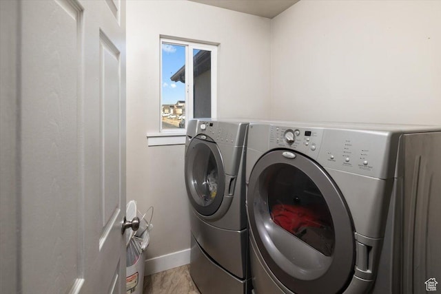 clothes washing area with separate washer and dryer