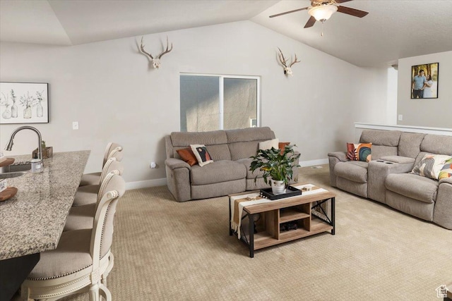 carpeted living room featuring ceiling fan and lofted ceiling