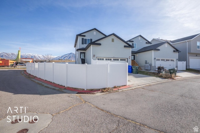 view of front of home with a mountain view and a garage