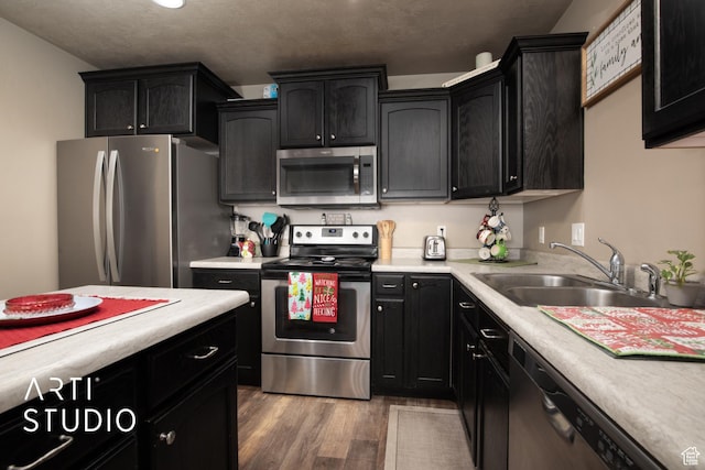 kitchen with sink, wood-type flooring, and stainless steel appliances