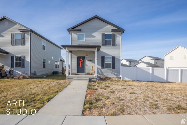 view of front property with a front yard and central AC