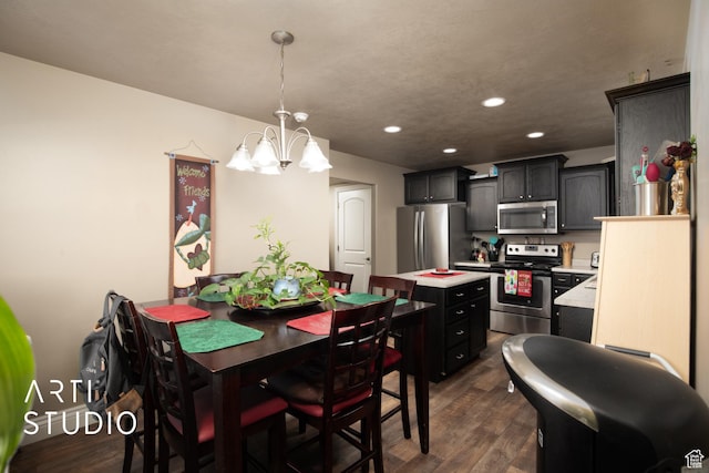 dining space featuring dark hardwood / wood-style flooring and an inviting chandelier