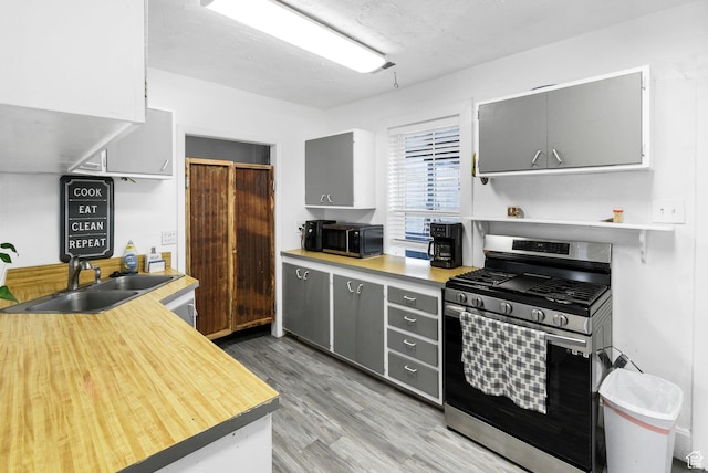 60 S 100 W, Monroe, UT 84754 - kitchen with gas stove, gray cabinets, sink, and hardwood / wood-style floors