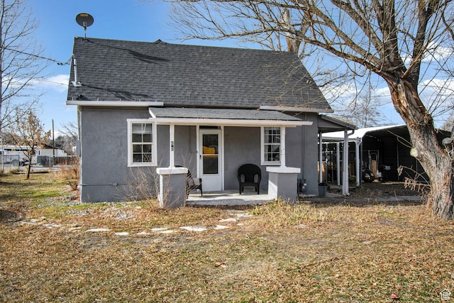 60 S 100 W, Monroe, UT 84754 - rear view of property featuring a shingled roof, stucco siding, and a carport