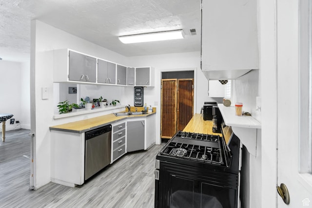 60 S 100 W, Monroe, UT 84754 - kitchen with gray cabinetry, dishwasher, sink, light hardwood / wood-style floors, and gas stove
