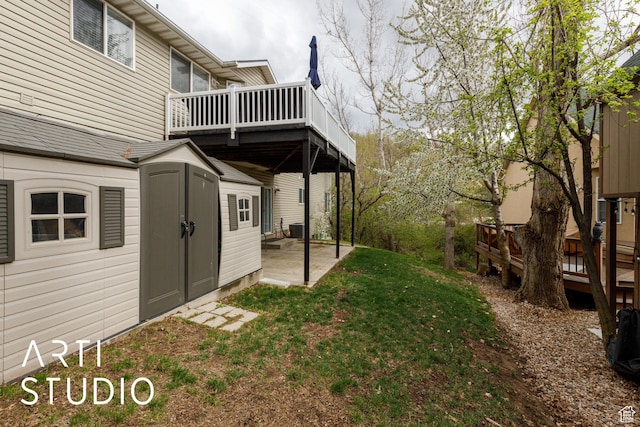 view of yard with central AC unit, a deck, a patio, and an outdoor structure