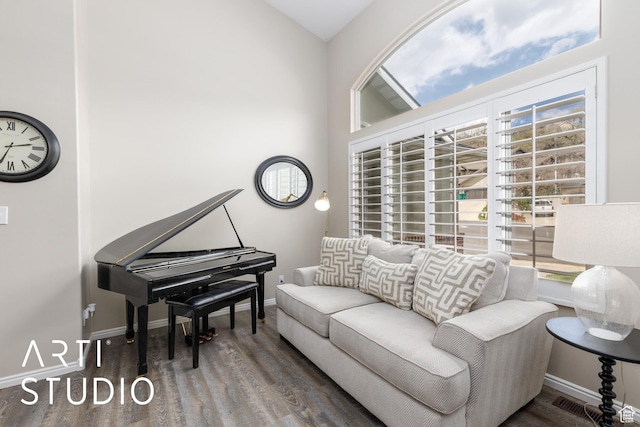 living area featuring baseboards and wood finished floors