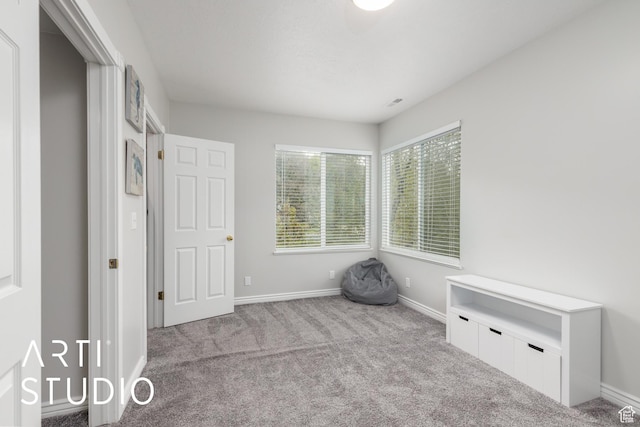 unfurnished bedroom with baseboards and carpet flooring