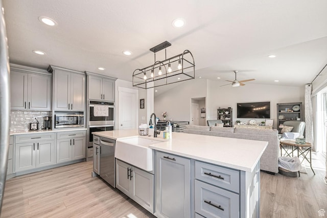 638 E Canyon Rim Rd N, Smithfield, UT 84335 - kitchen featuring gray cabinetry, lofted ceiling, sink, ceiling fan, and appliances with stainless steel finishes